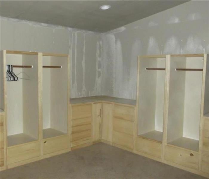 Large walk-in closet with frost on walls and ceiling after pipe burst during polar vortex.